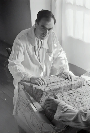 A modern laboratory setting with researchers examining porous materials under microscopes.