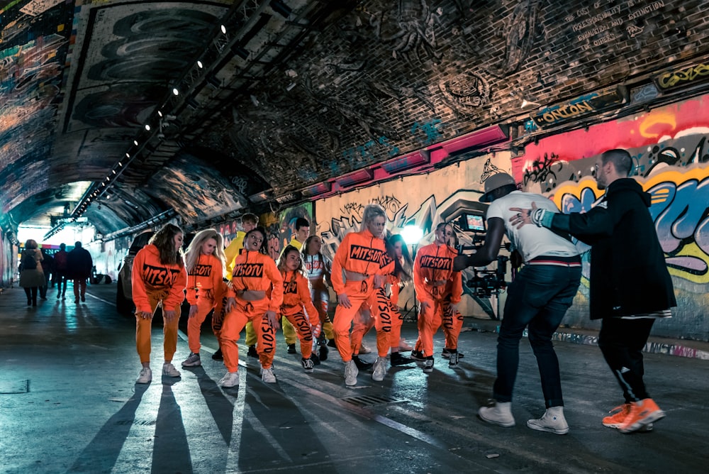 group of people in orange and white shirts