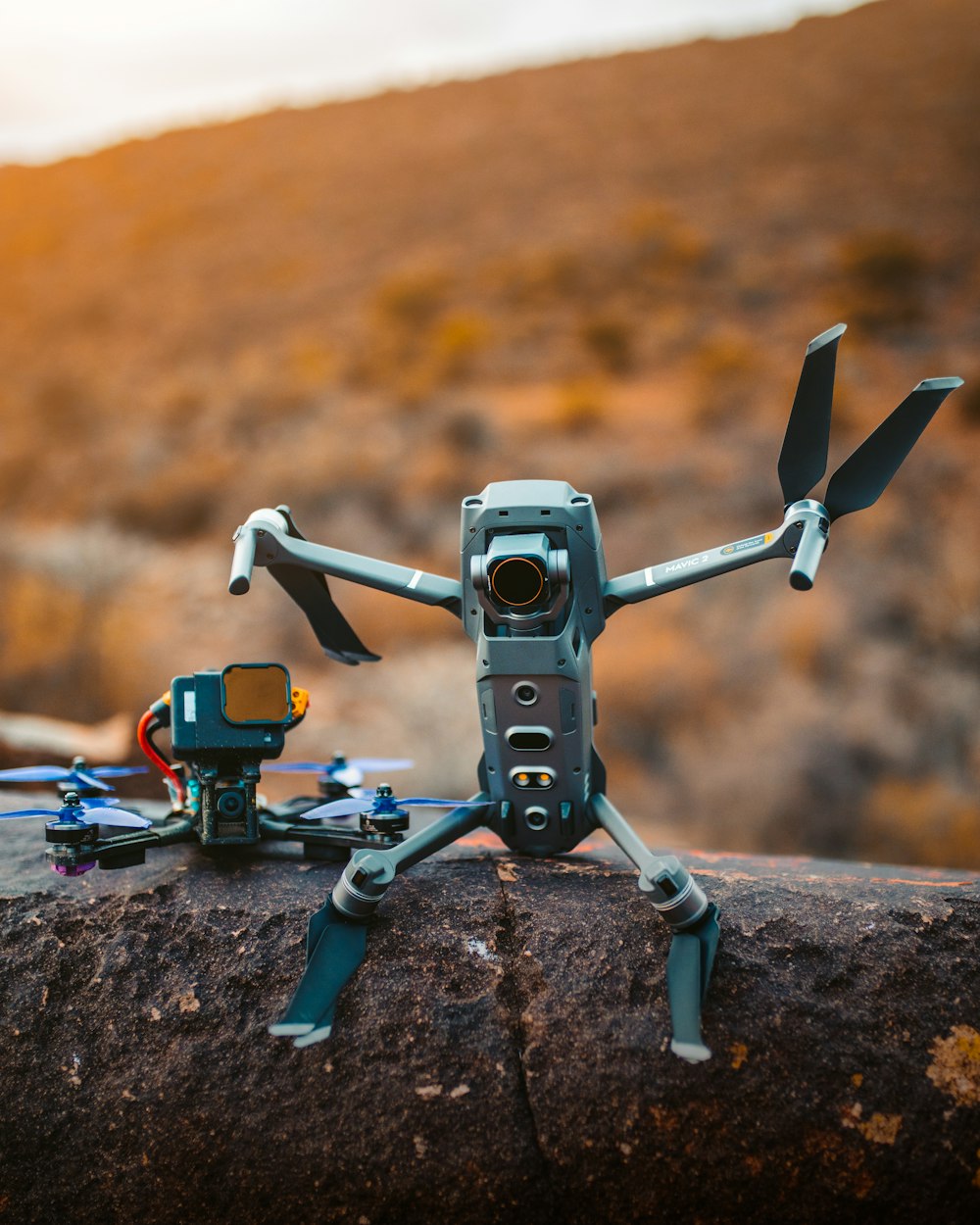 gray and black drone on brown rock during daytime