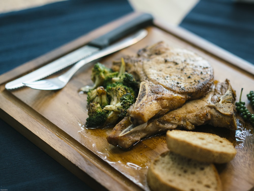 grilled meat on brown wooden chopping board