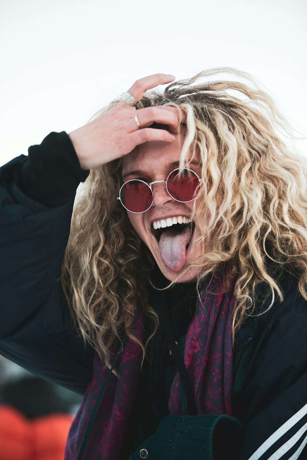 woman in black jacket wearing brown sunglasses