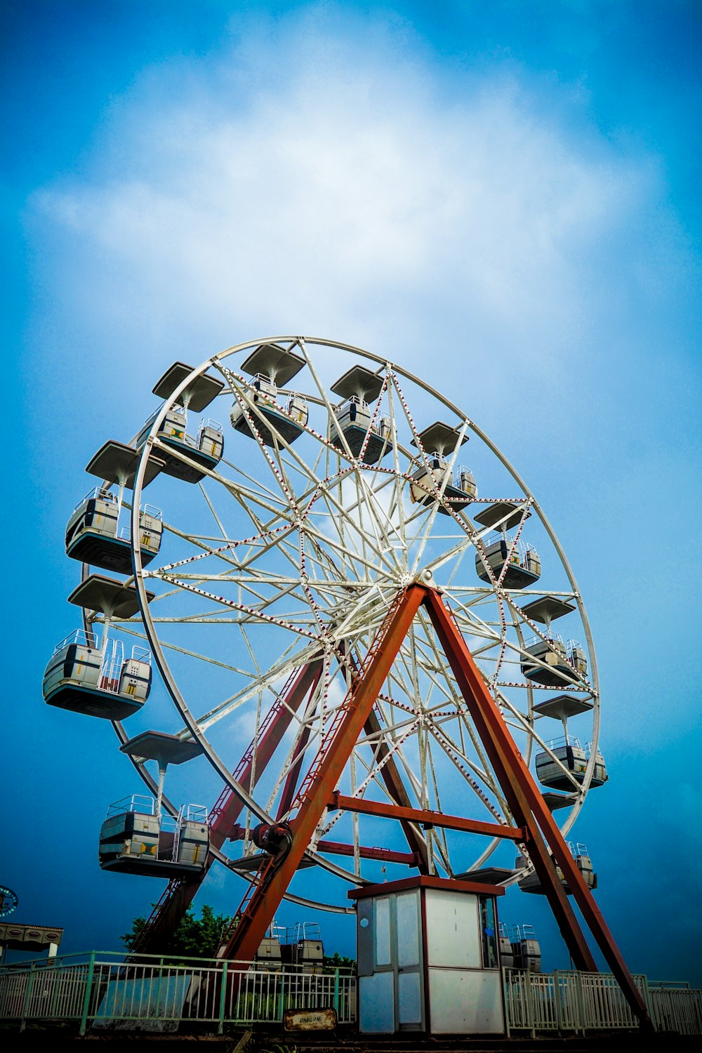 white and red ferris wheel under blue sky during daytime