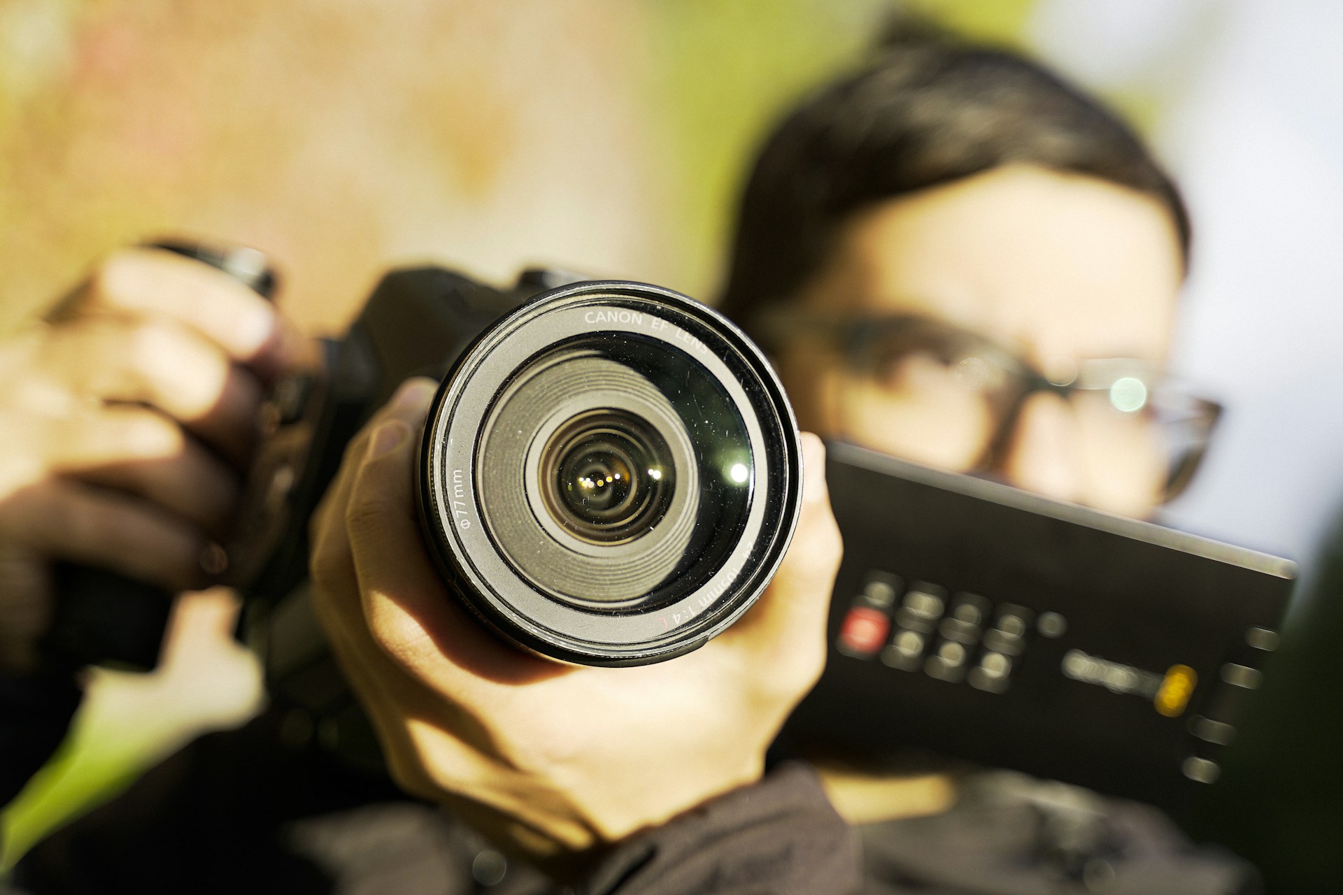 person holding black camera lens