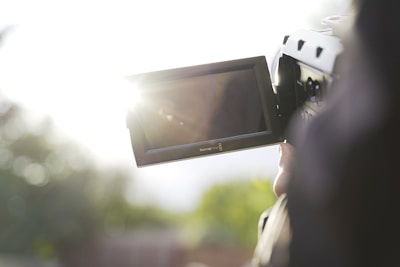 person holding black flat screen tv