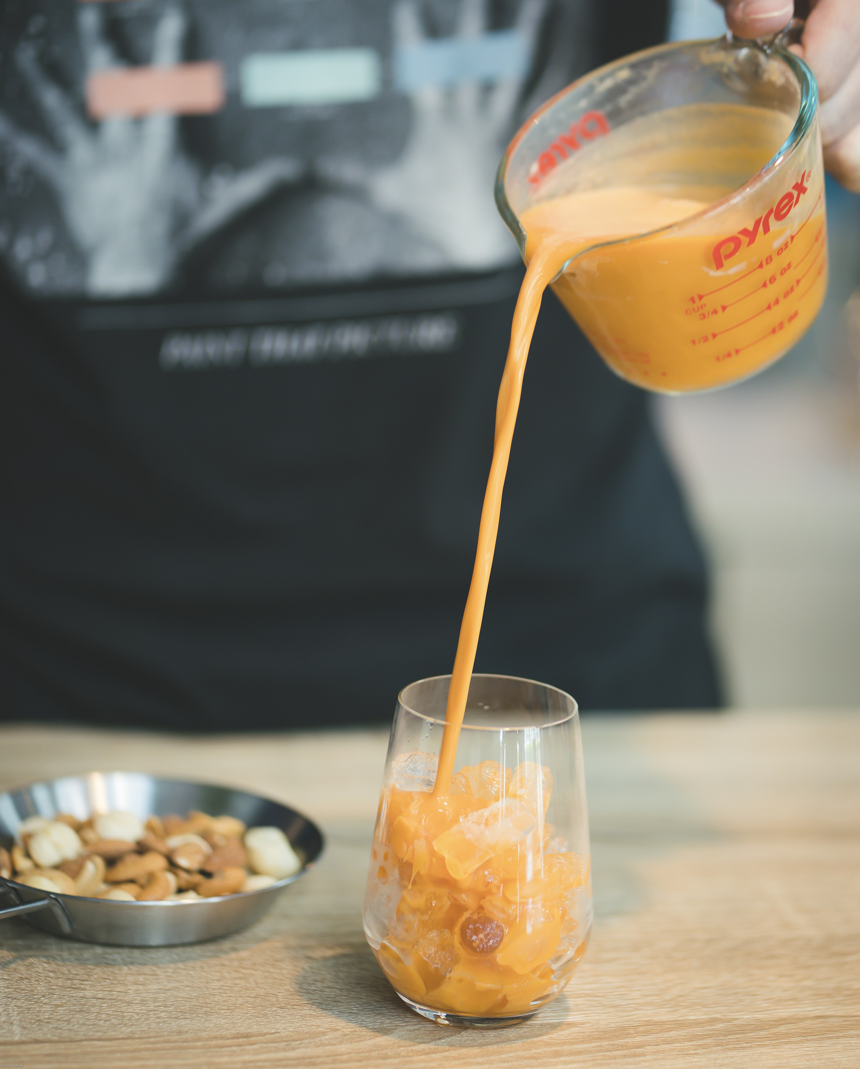 orange juice in clear plastic cup with yellow straw