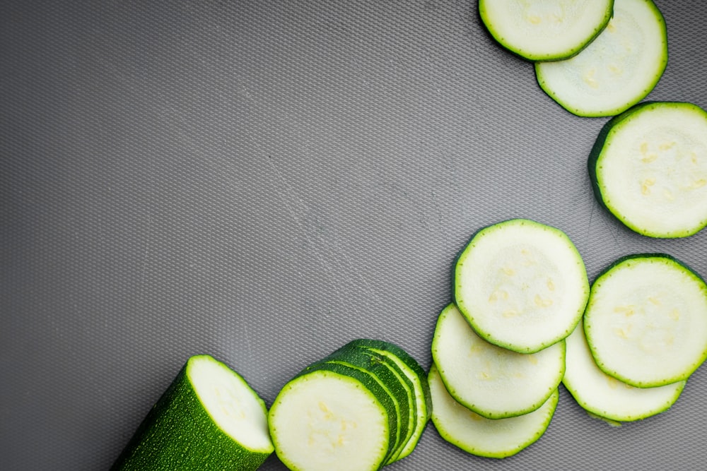 sliced cucumber on gray textile