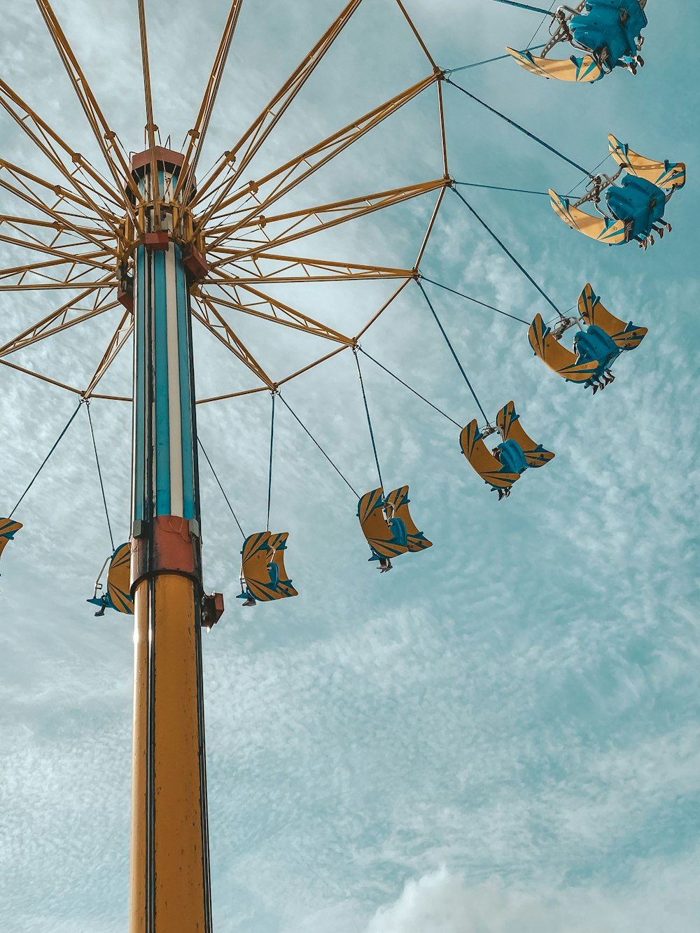 people riding on swing ride during daytime