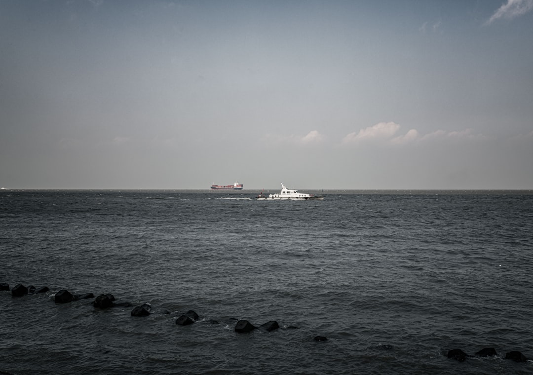 white ship on sea under blue sky during daytime