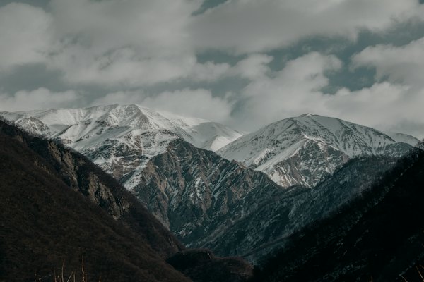 Snow covered mountains under cloudy sky during daytime — Sheki, Azerbaijan