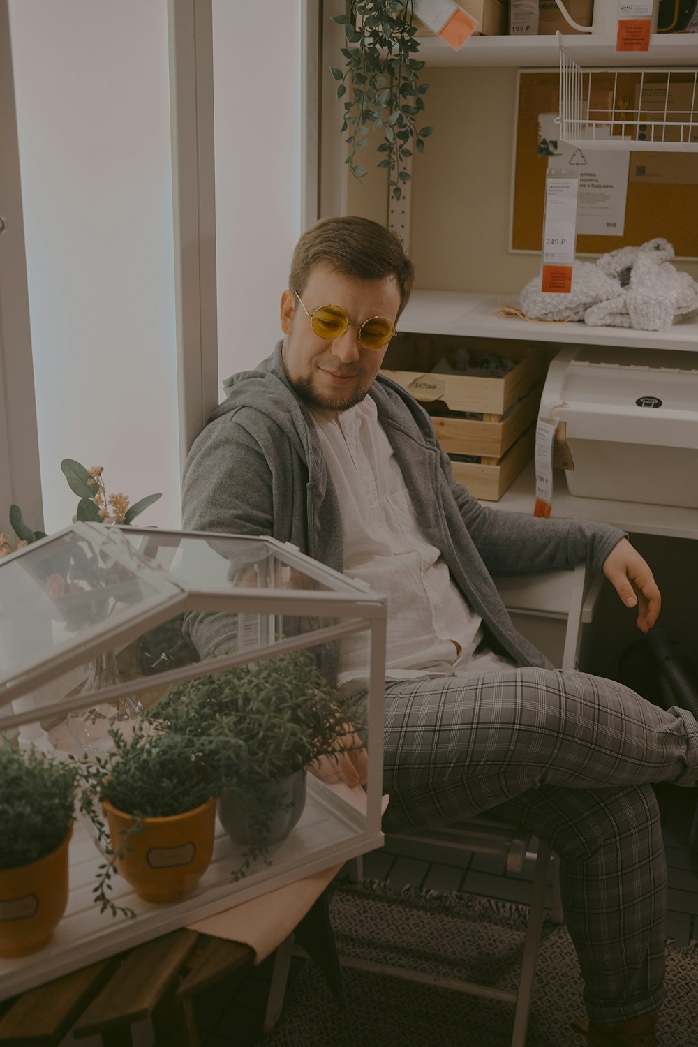 man in gray sweater sitting on chair