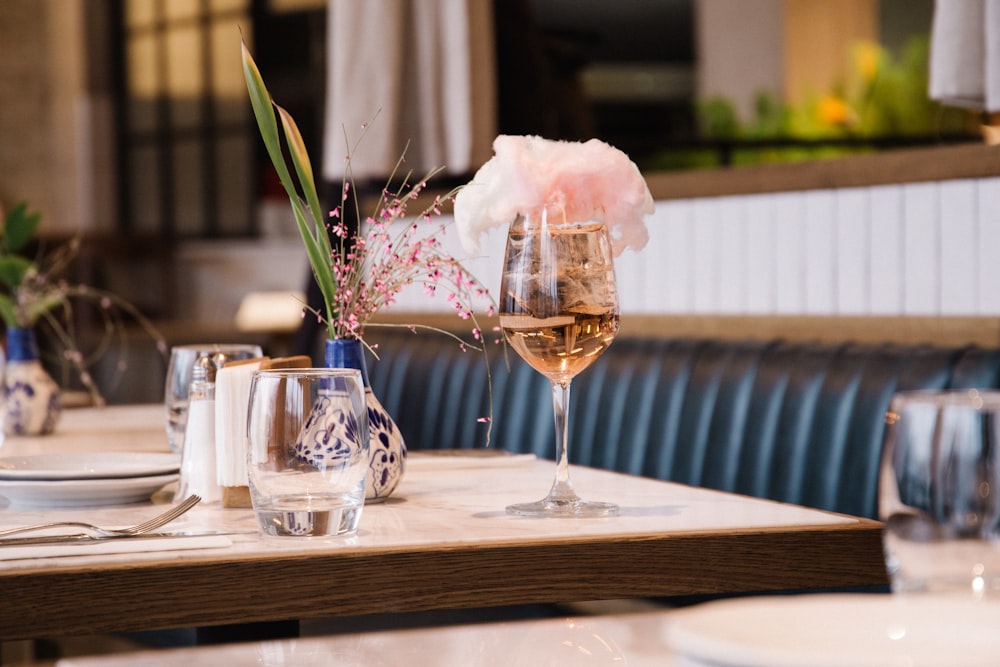 pink rose in clear glass vase on table