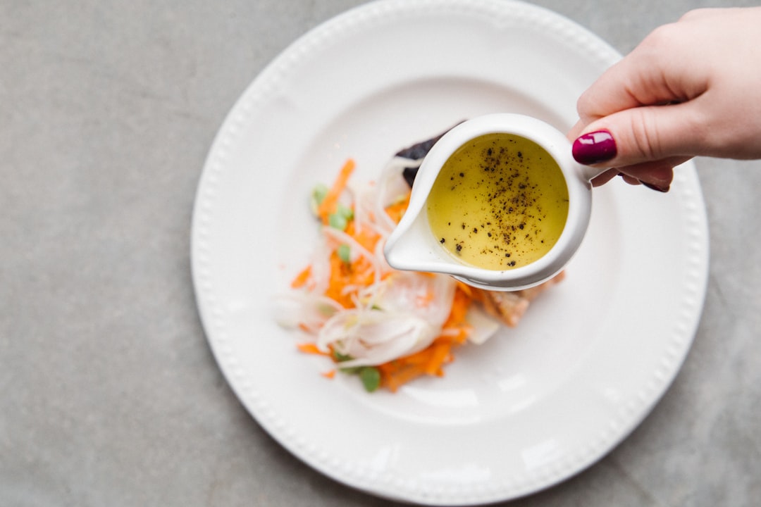 white ceramic plate with yellow soup