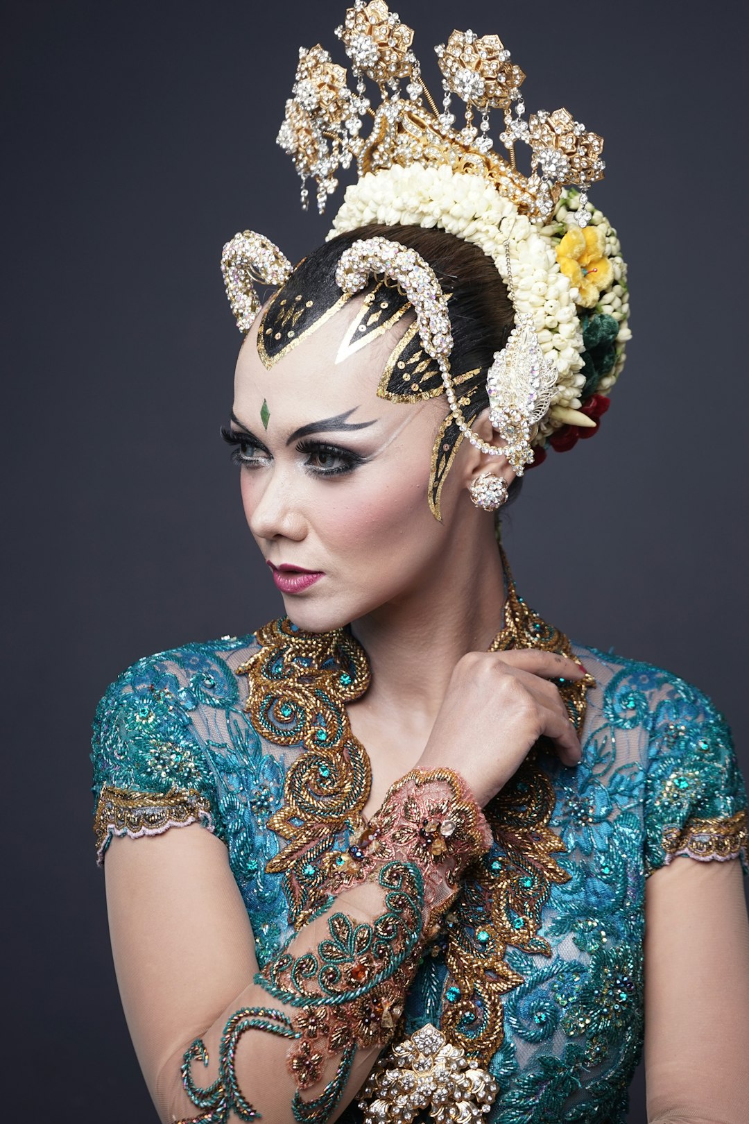 woman in blue and brown floral dress wearing gold crown