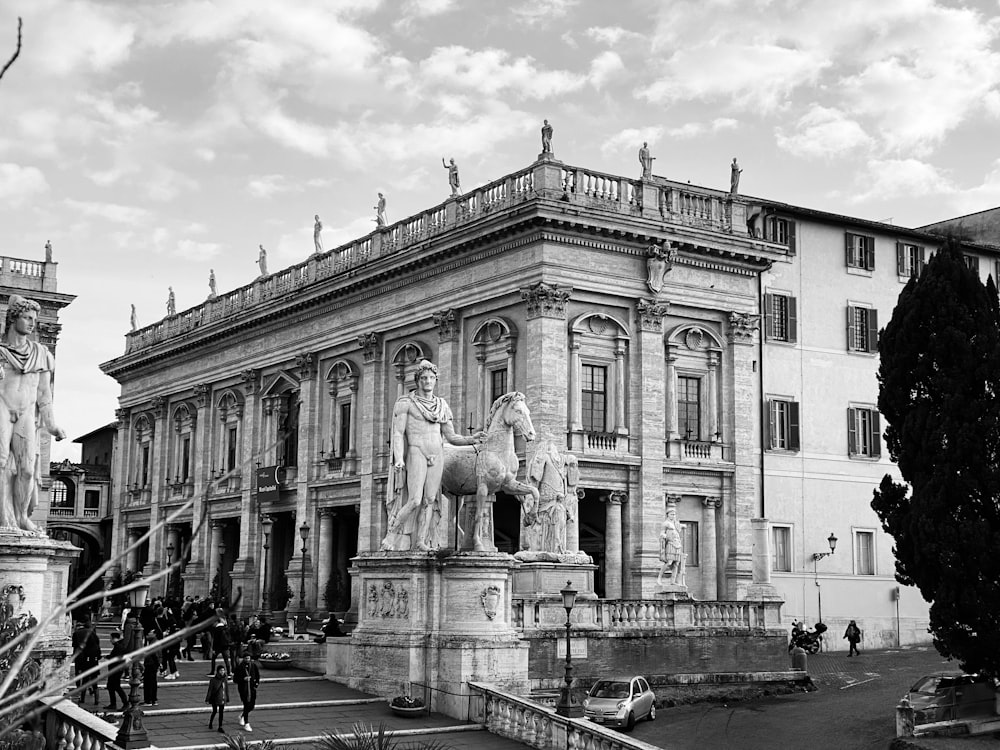 grayscale photo of people walking near building