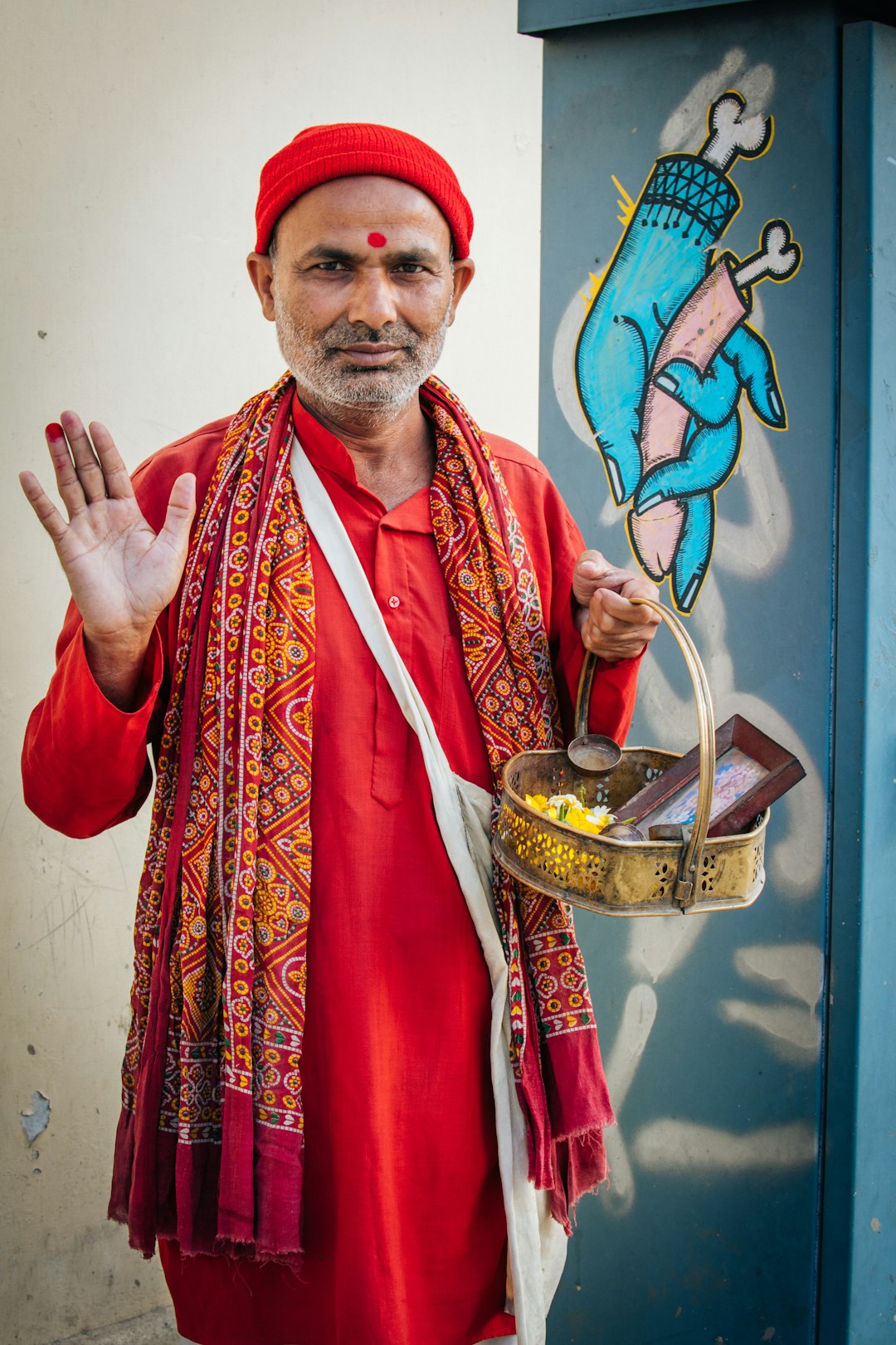 man in red and white robe holding gold bowl