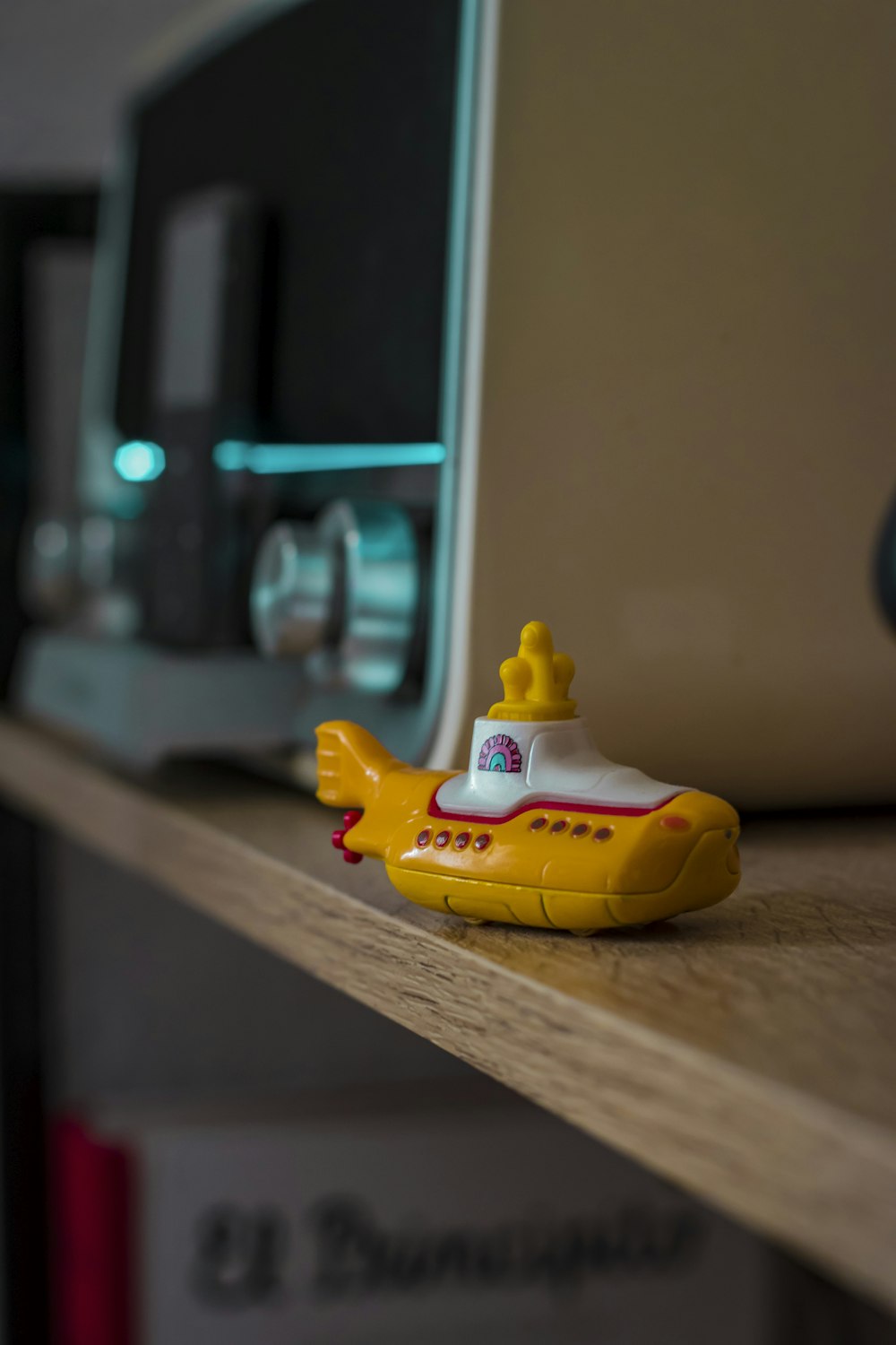 yellow duck plastic toy on brown wooden table