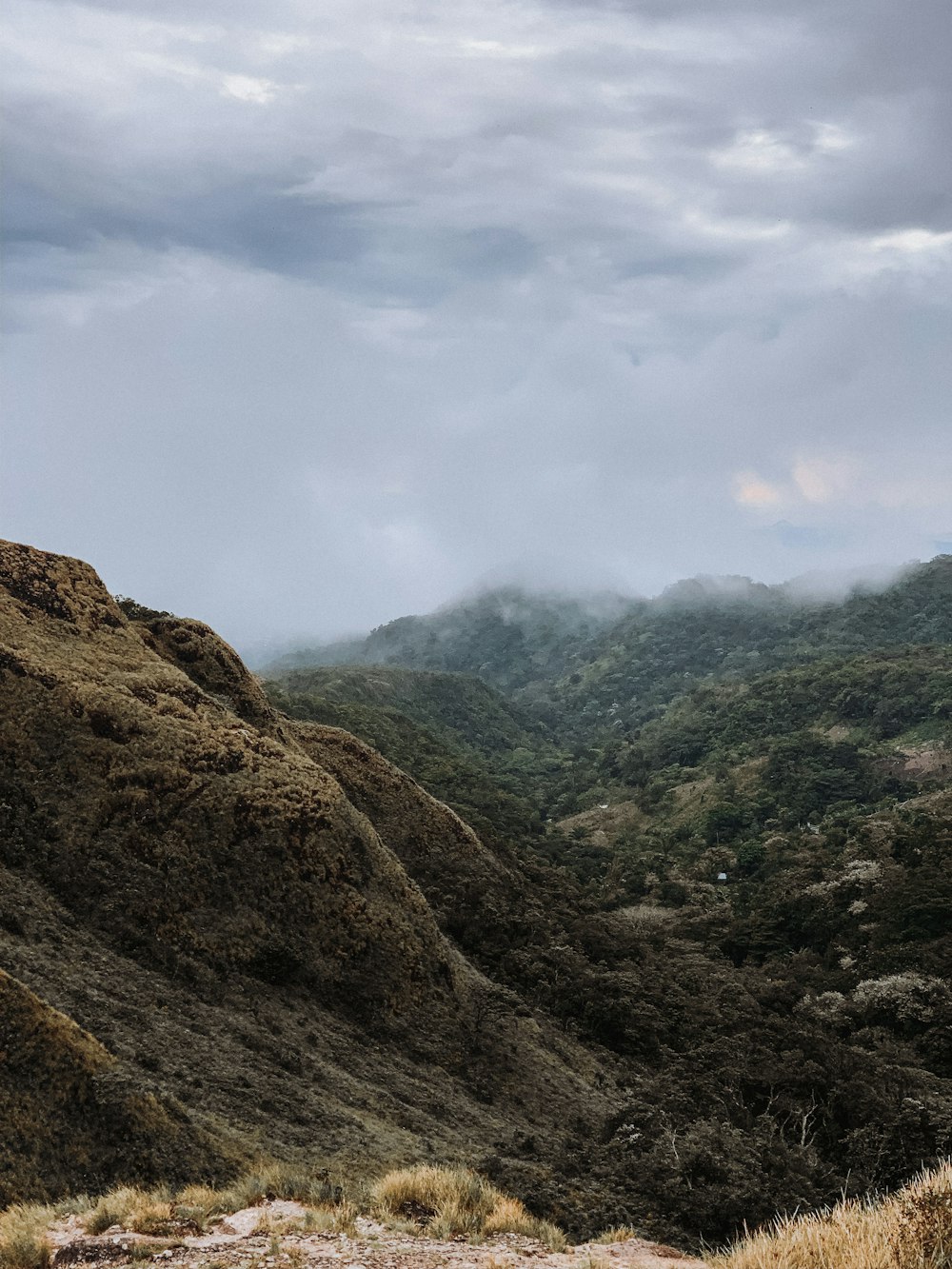 green and brown mountains under white clouds during daytime