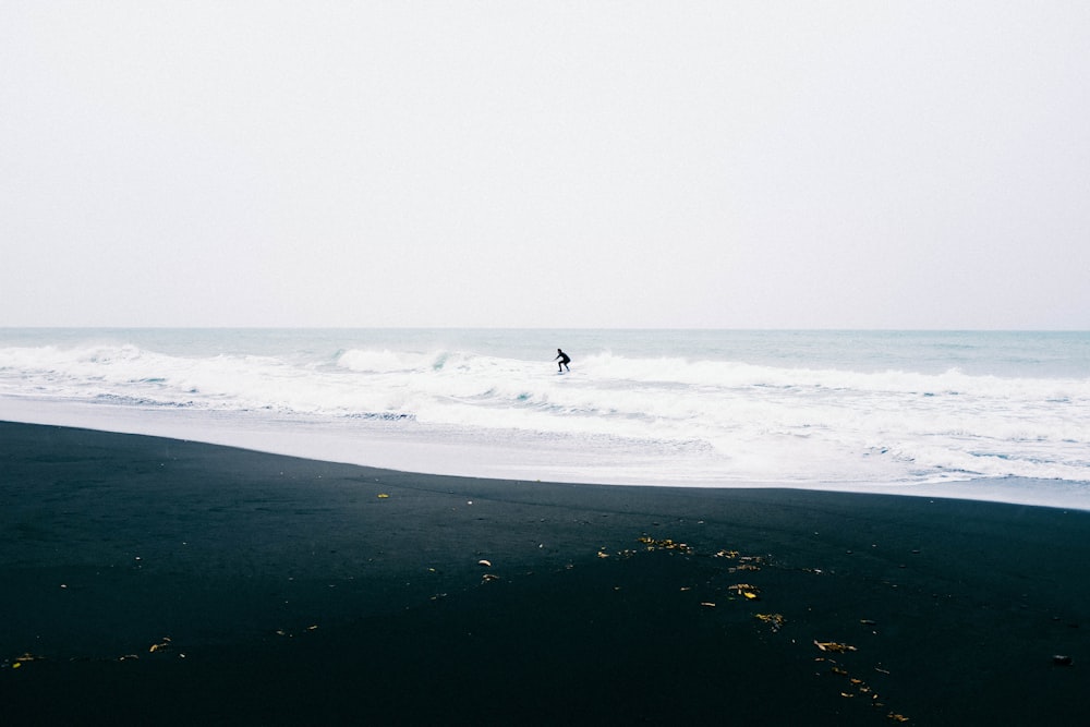 person surfing on sea during daytime