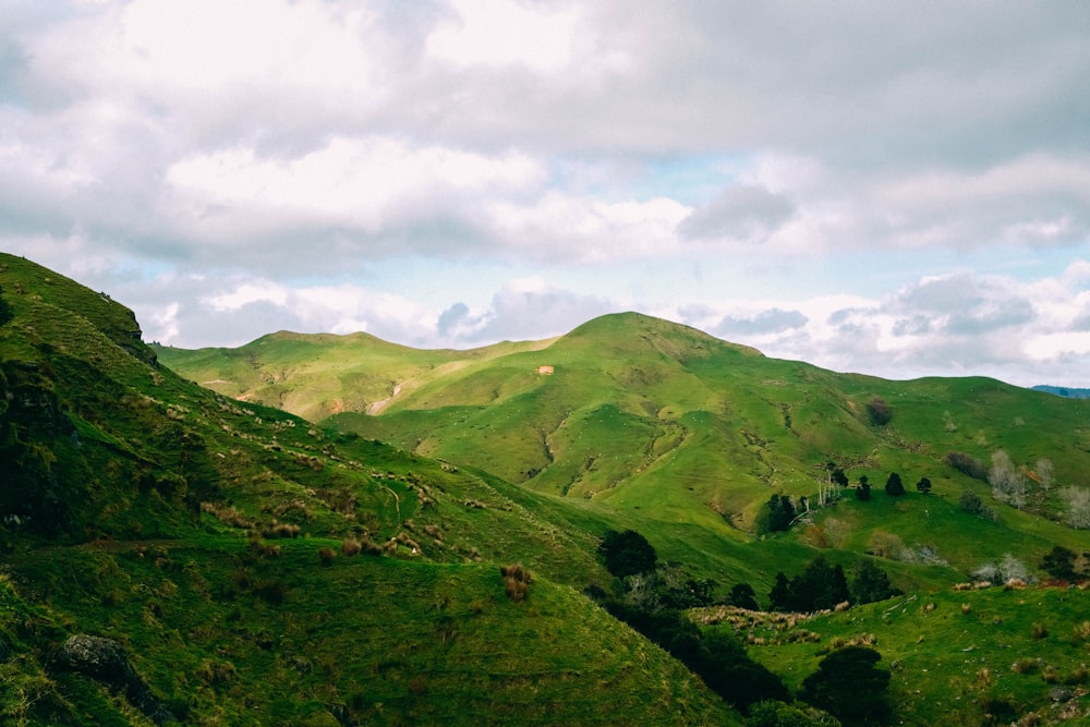 green mountains under white clouds during daytime