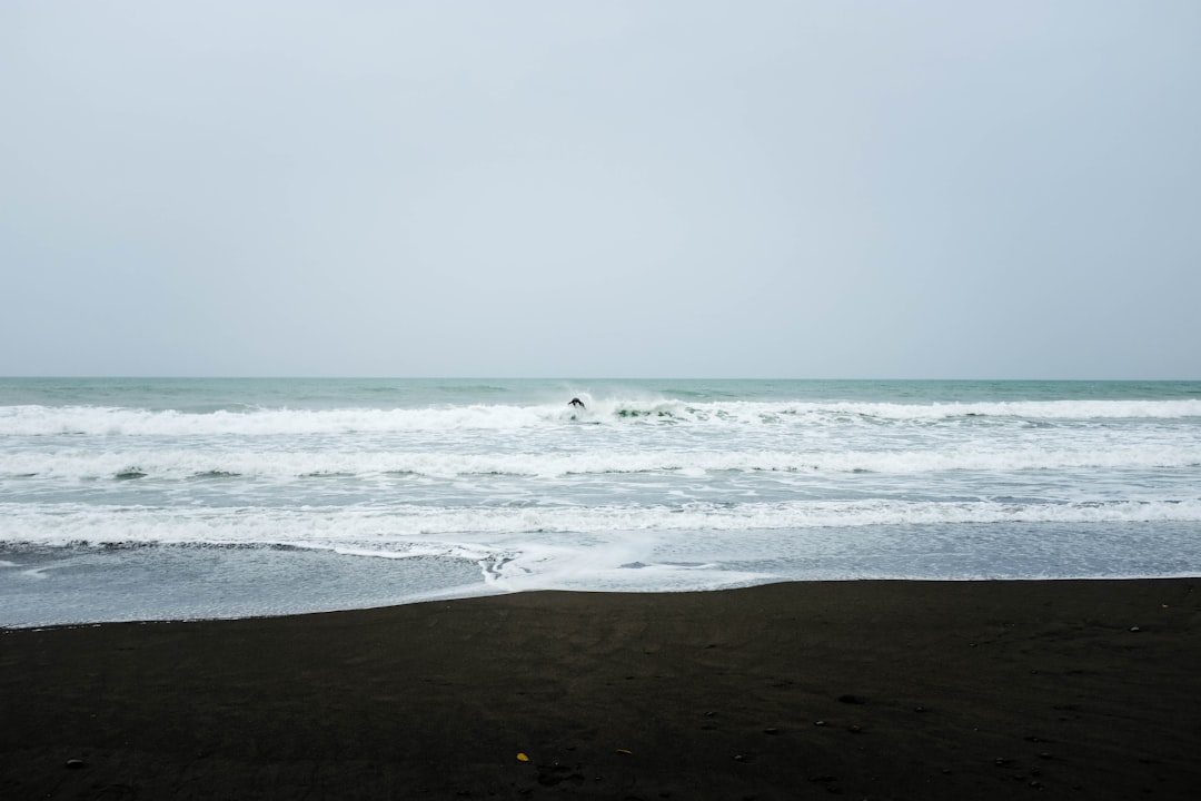 person surfing on sea waves during daytime