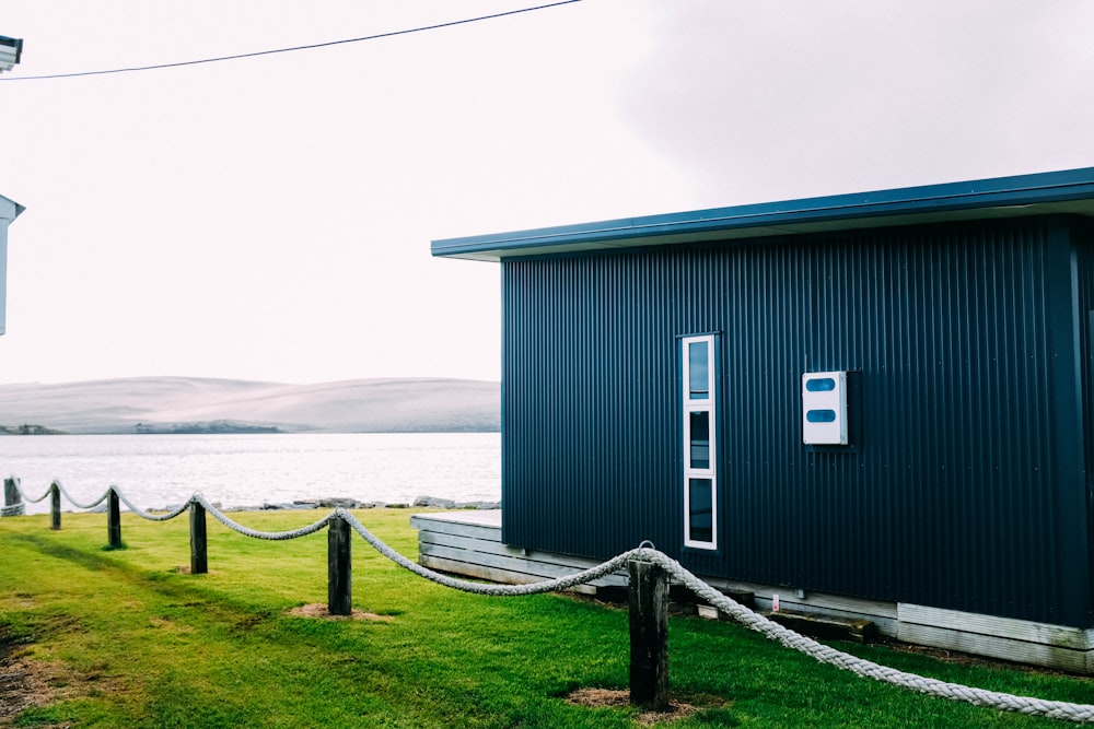 blue wooden house near body of water during daytime