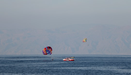 red and yellow parachute over the sea during daytime in Kish Iran