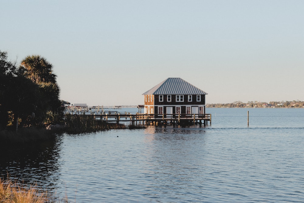 brown wooden house on body of water during daytime