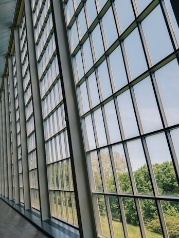 A panoramic glass wall that opens up to a scenic view.