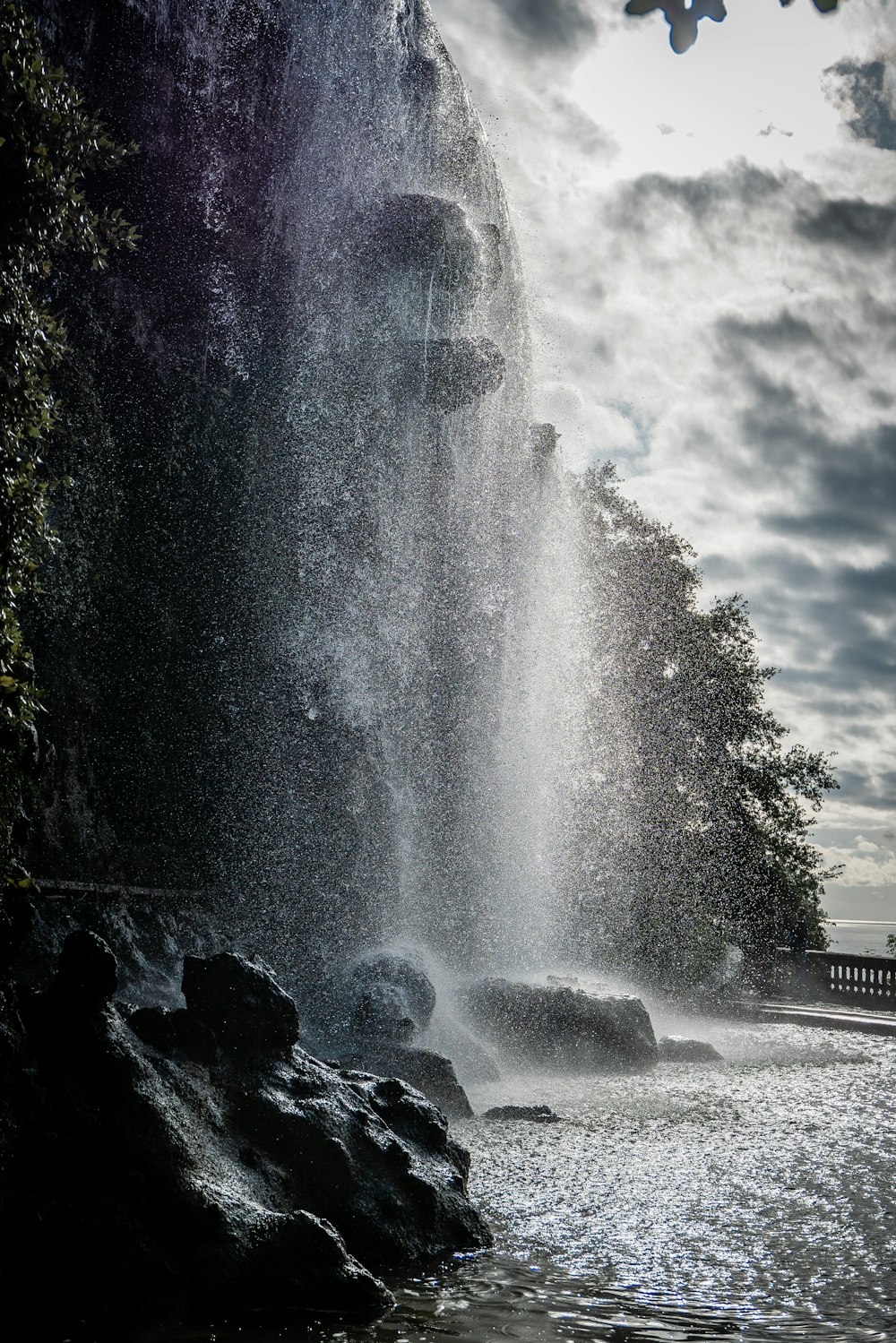 water fountain near green trees during daytime