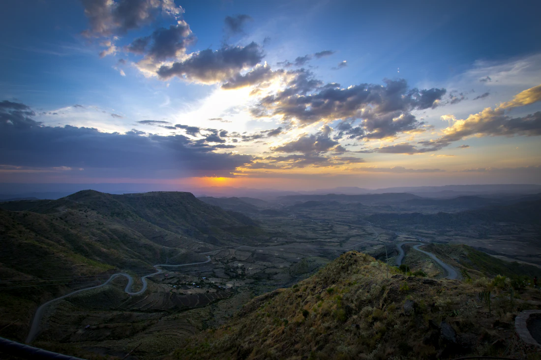 The jagged green peaks and deep escarpments of the Simien Mountains at sunset in Ethiopia