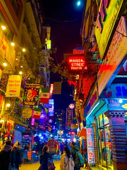 people walking on street during night time