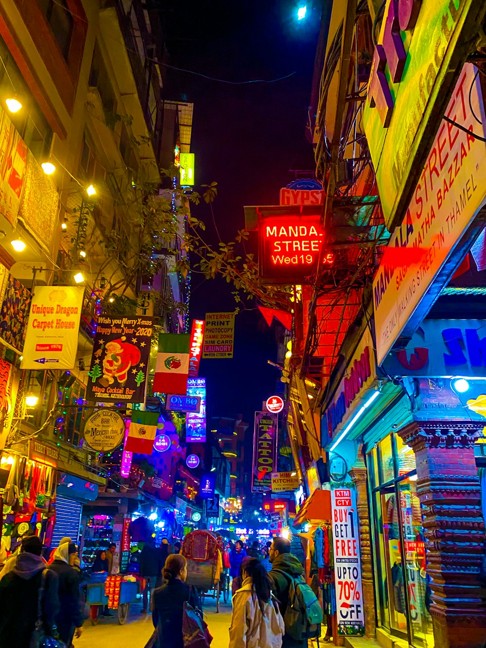 people walking on street during night time