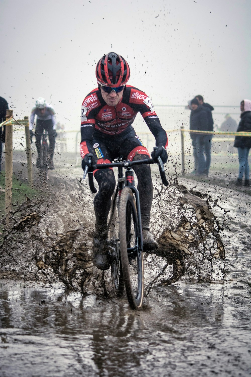 man in red and black jacket riding on bicycle