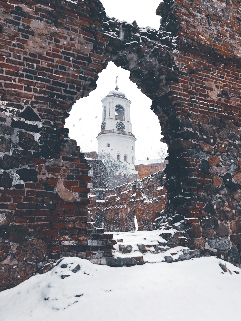 brown brick wall with snow