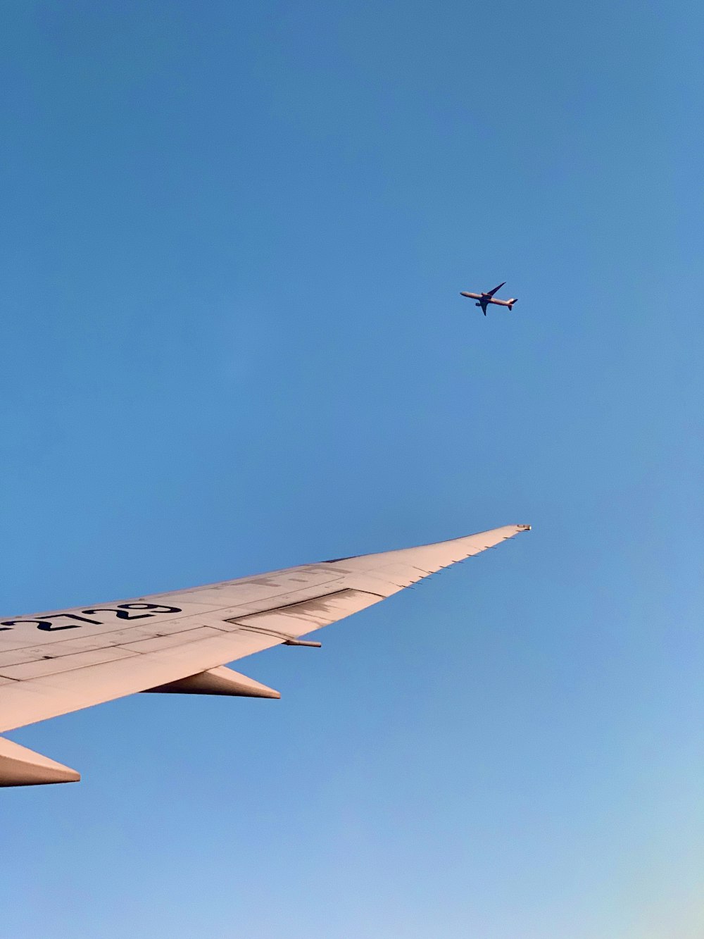 white and black airplane under blue sky during daytime