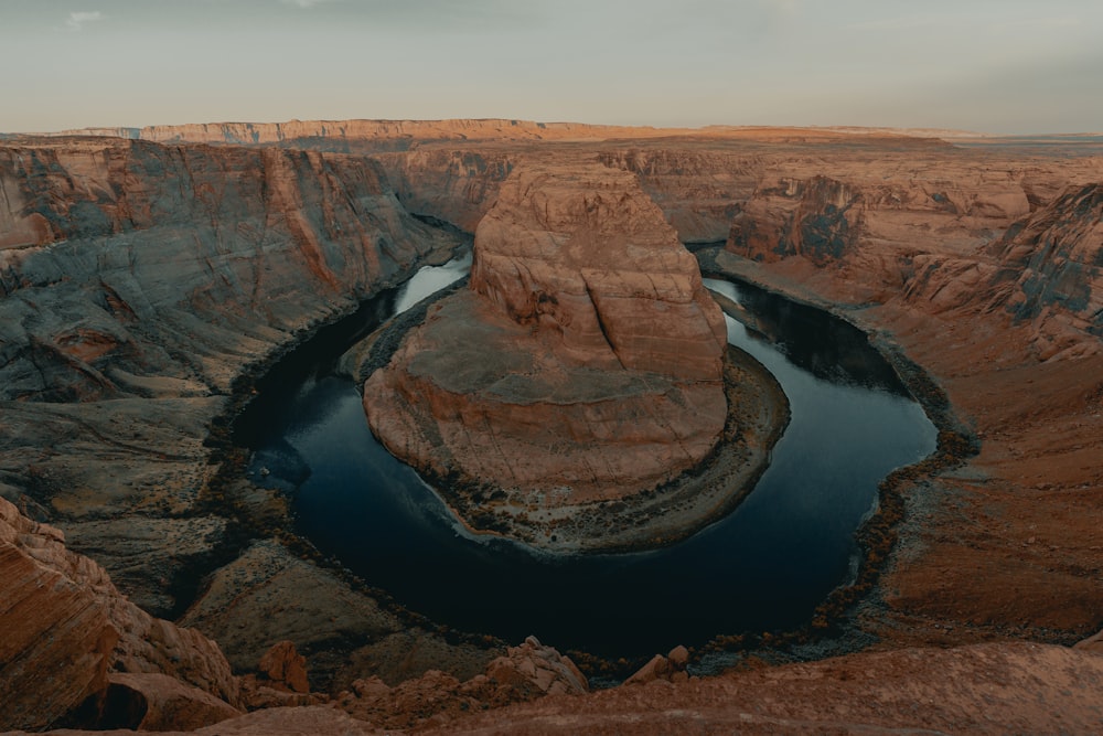 brown rock formation near river during daytime