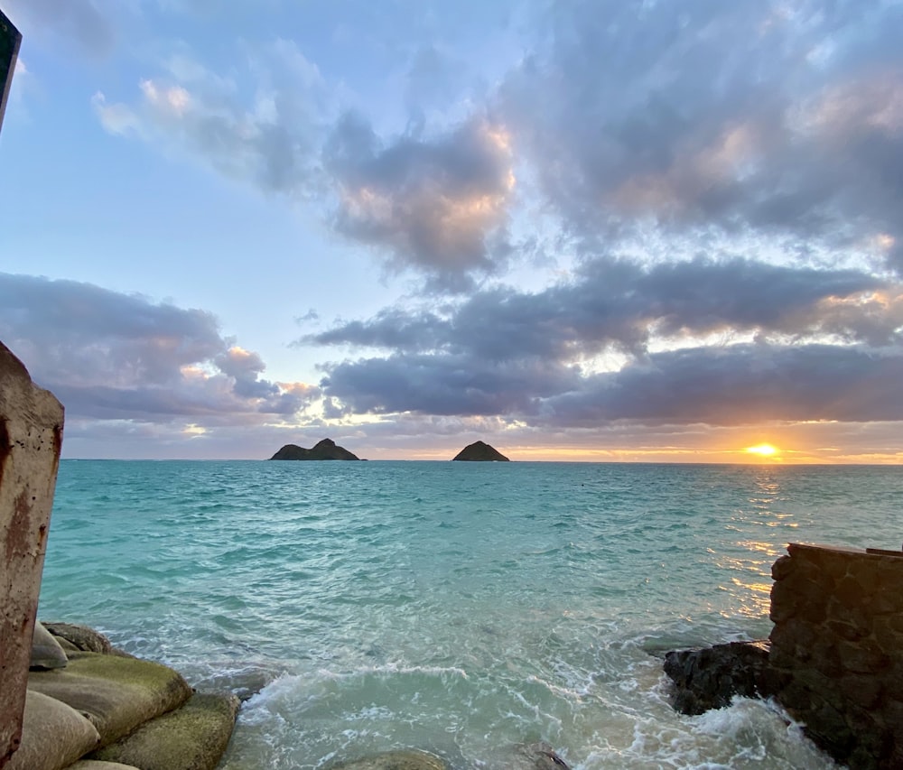 ocean waves crashing on rocks during sunset