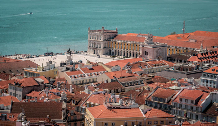 Lisbon from above, terracotta rooftops running down to the Tagus