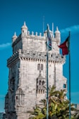 brown concrete building with flags