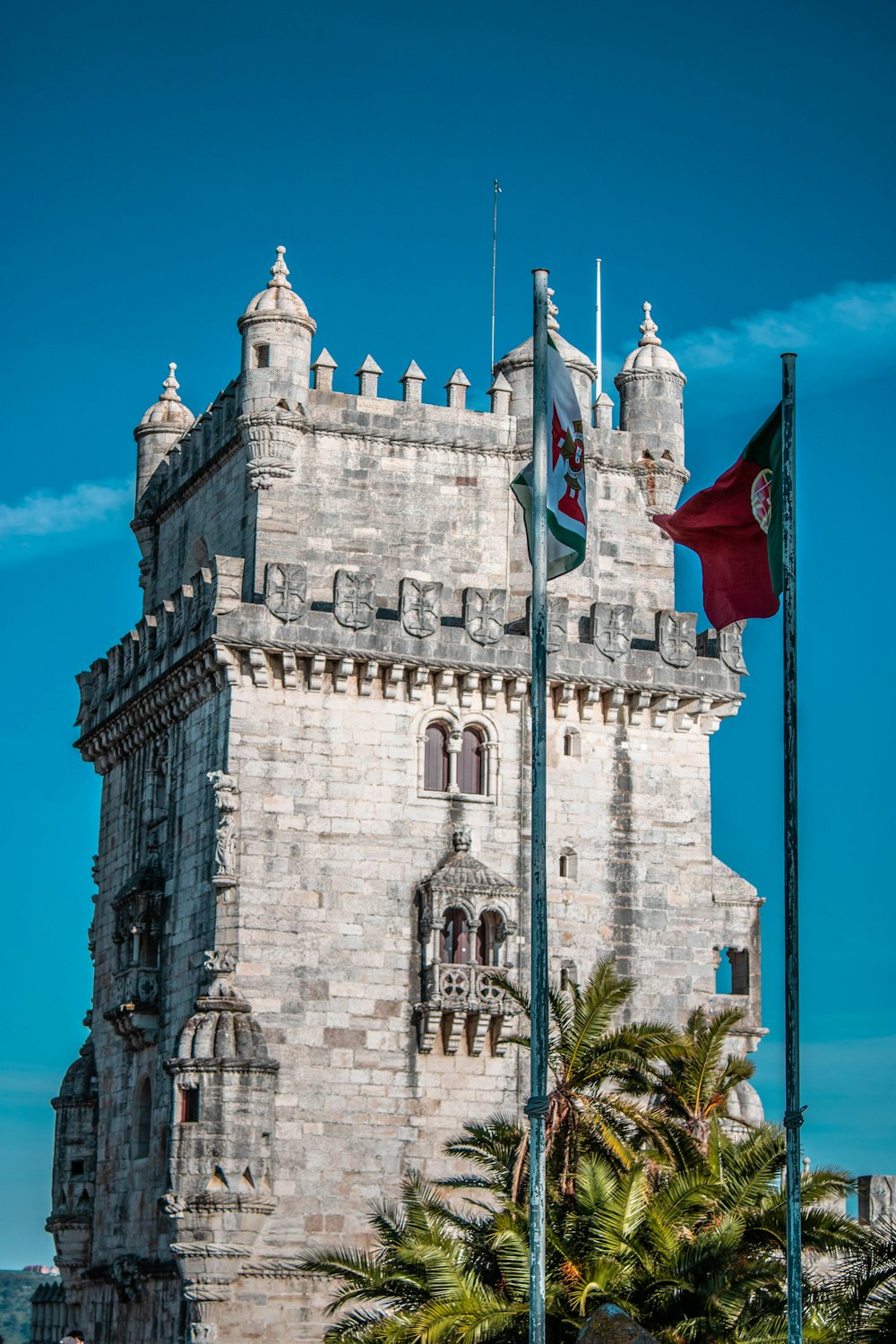 brown concrete building with flags