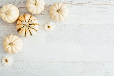 white garlic on white wooden table pumpkin teams background