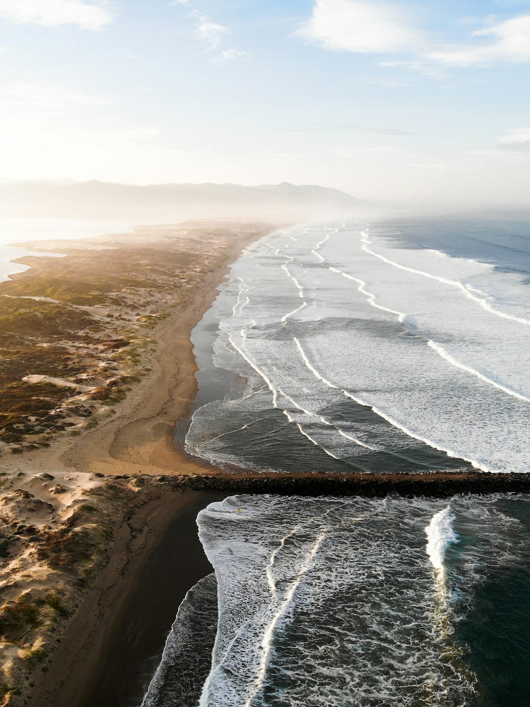 ocean waves crashing on shore during daytime