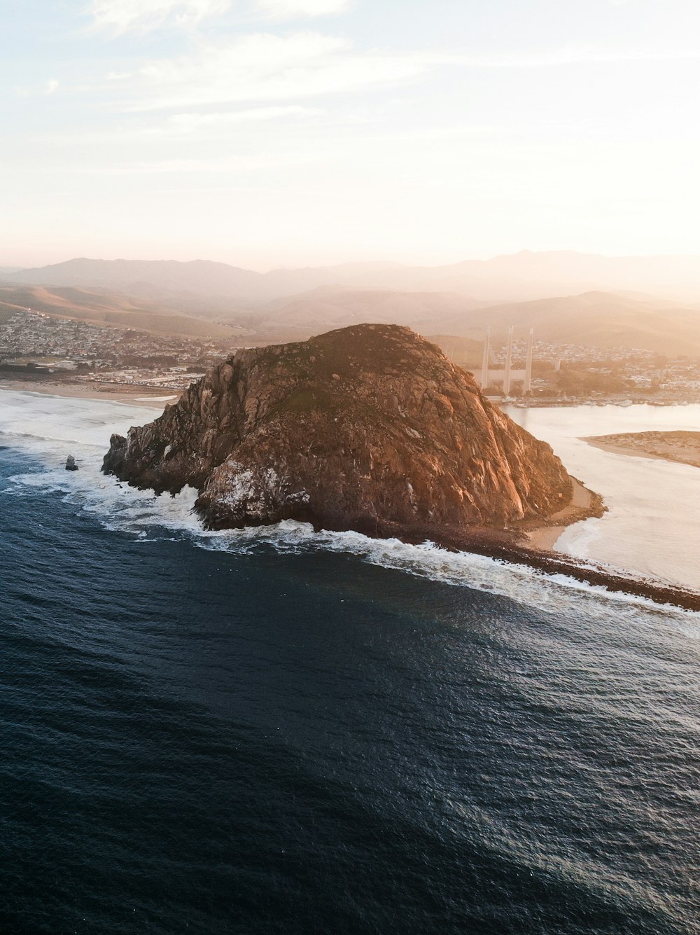 brown rock formation on sea during daytime