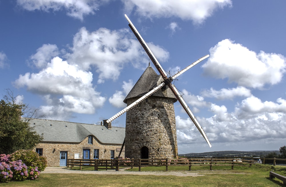 brown and gray windmill under blue sky during daytime