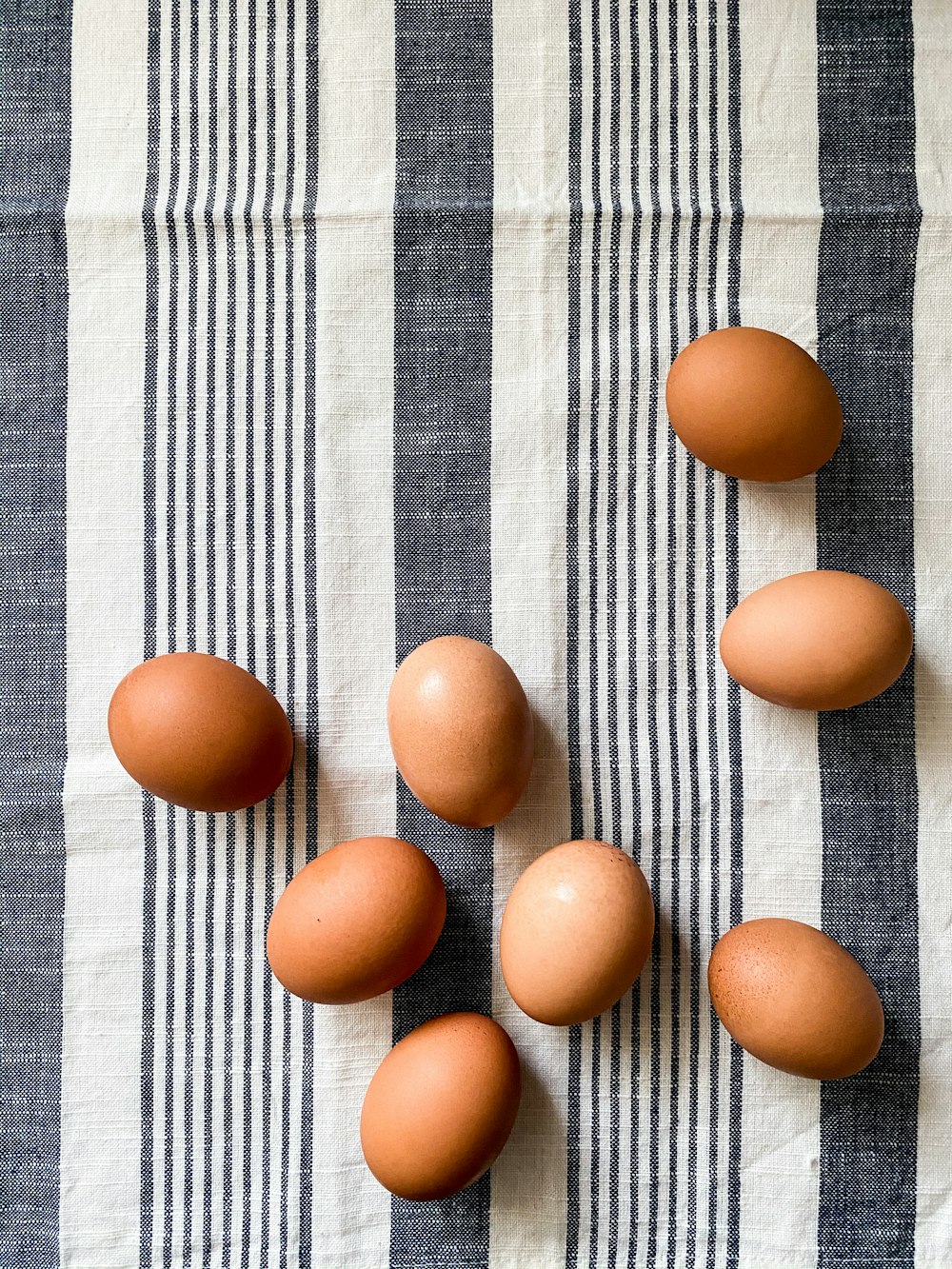 brown egg on blue and white plaid textile