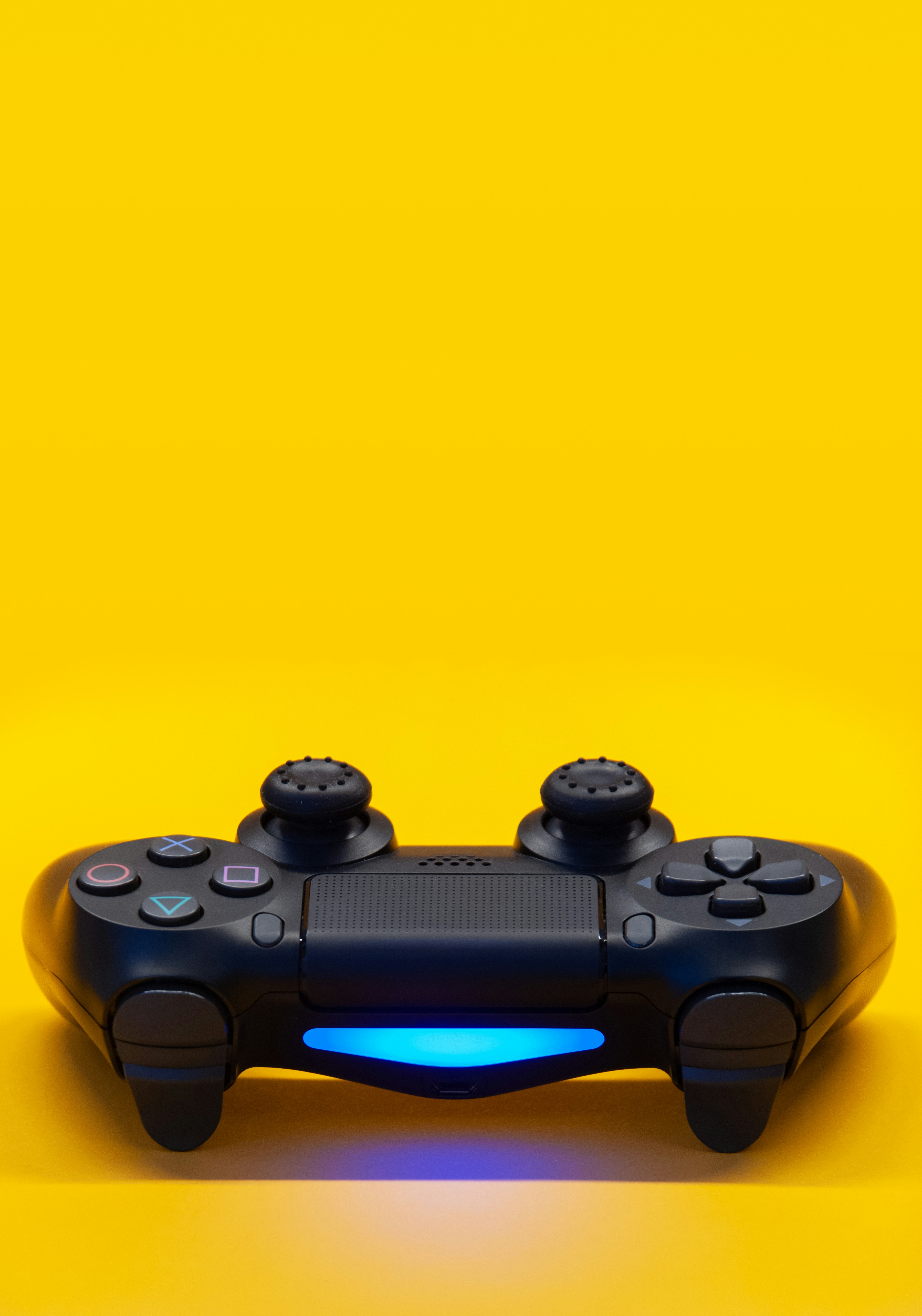 Black  controller on a yellow background