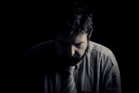 man i grå skjota med vit slips