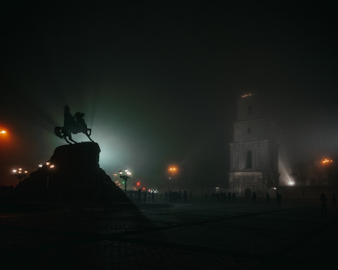 people walking on sidewalk during night time