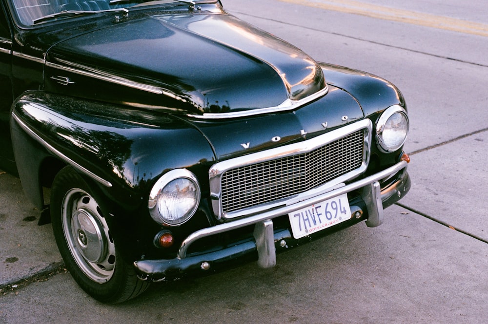 black car on gray asphalt road during daytime