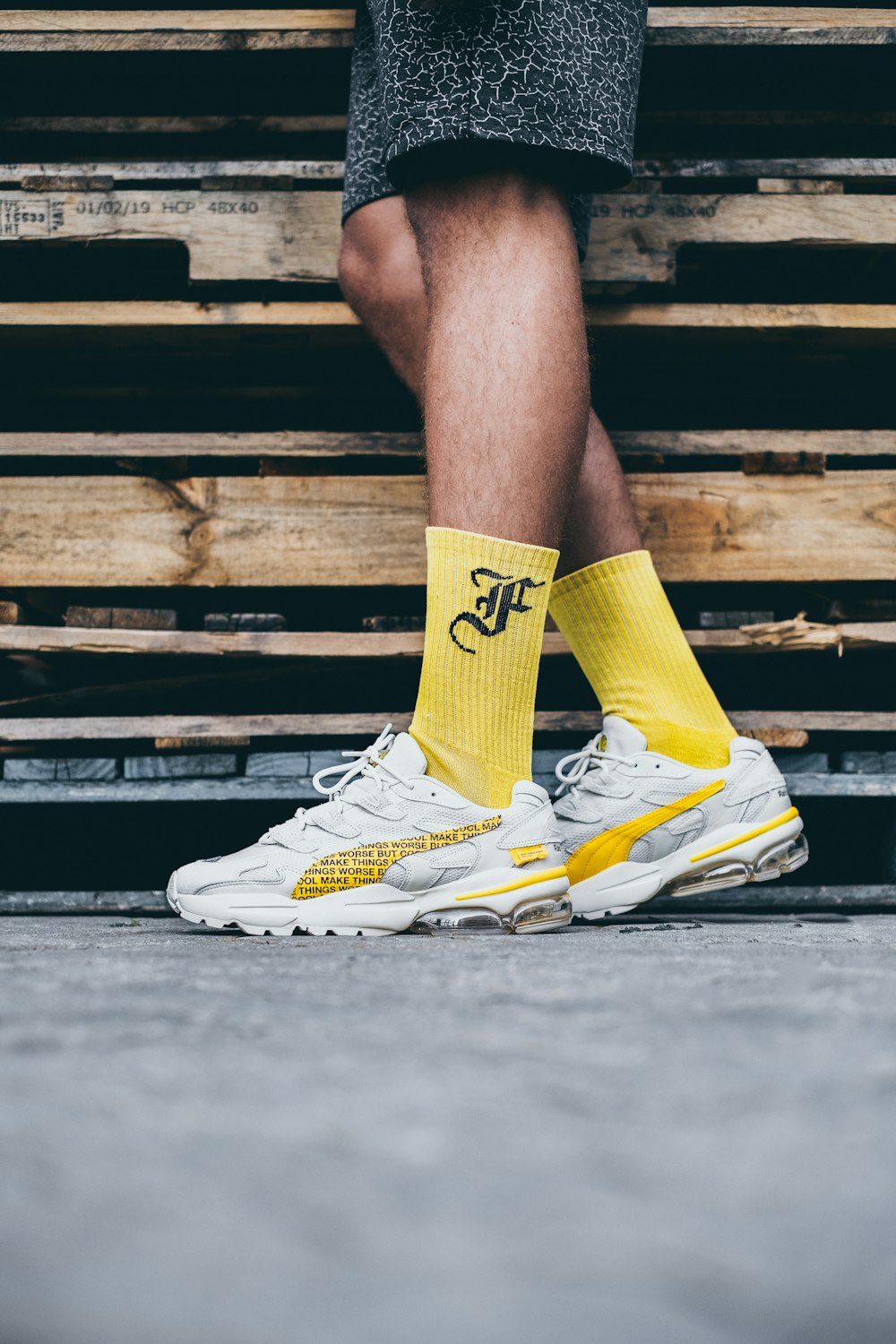 person in yellow and white nike athletic shoes